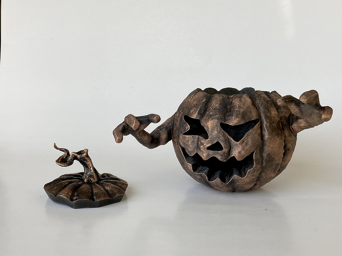 detailed black gold halloween pumpkin sculpture expressive character decorative art